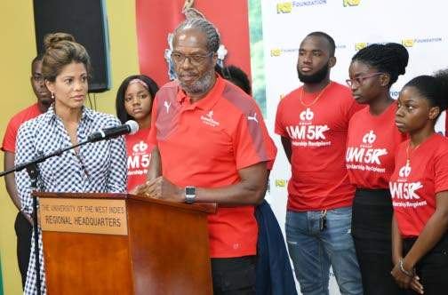 Alfred “Frano” Francis, race director, CB Group/UWI 5K, addresses the launch of the event last Wednesday at The UWI Regional Office. Scholarships were also distributed to students for the 2019-2020 school year. Looking on is Elizabeth Buchanan-Hind (left), chair of the fund-raising event to raise funds for students wishing to pursue tertiary education, but in need of financial assistance.